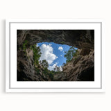 Landscape framed artwork showcasing intricate canyons in vibrant earth tones, set within a sleek white mat for a modern aesthetic, ideal for home decor.