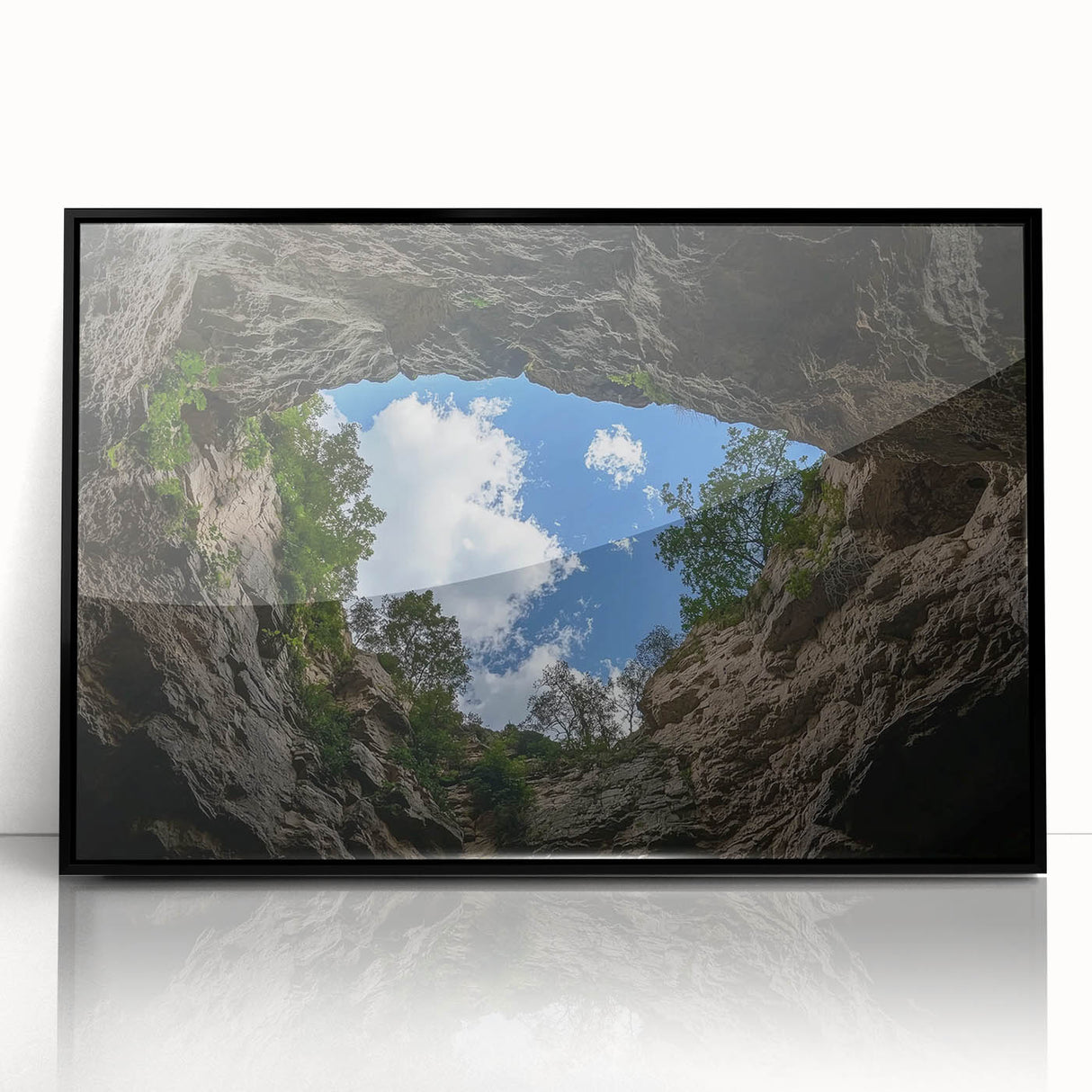 Framed acrylic artwork showcasing a stunning landscape of canyons with rich colors, presented in a sleek black frame, perfect for modern home decor.