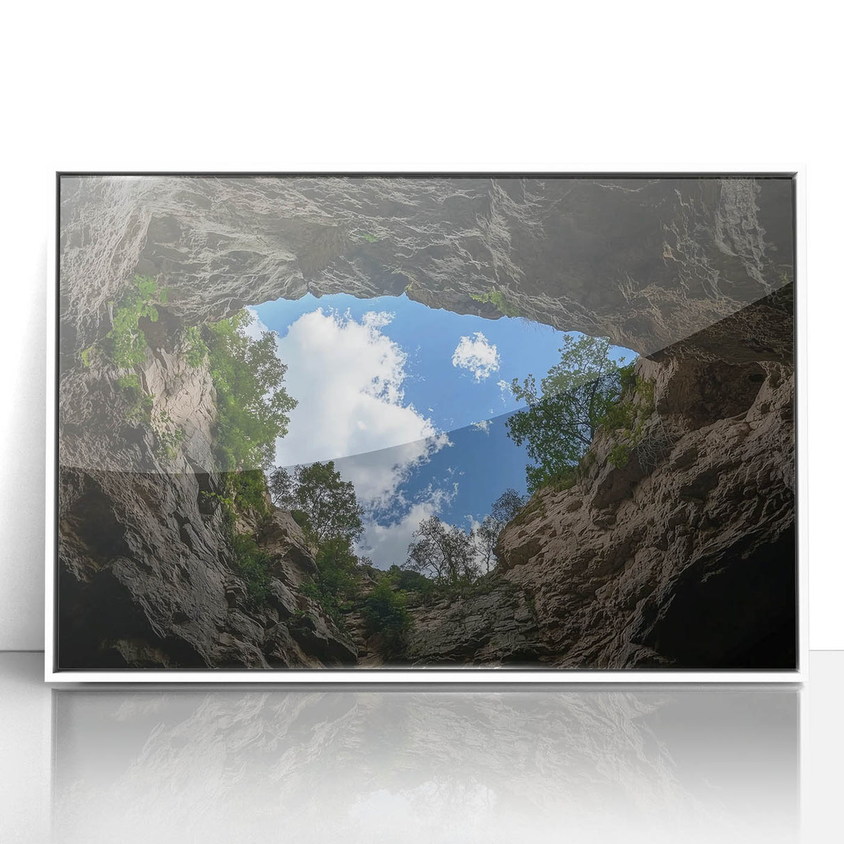 Framed acrylic landscape artwork depicting vibrant canyons in rich earthy tones, set against a crisp white frame, perfect for enhancing modern home decor.