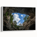 Framed landscape canvas depicting vibrant canyons in warm hues, featuring a sleek white frame that enhances its natural beauty, ideal for home decor.