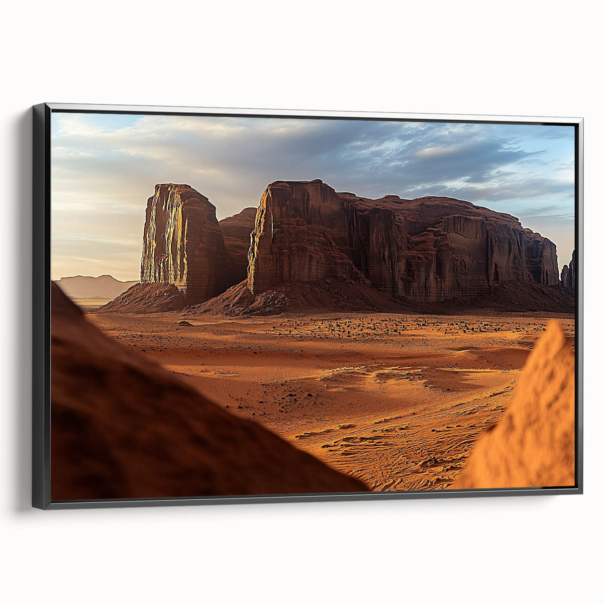 Framed canvas artwork depicting a desert landscape with warm tones of orange and brown, showcasing a black frame with a sleek side view, perfect for home decor.