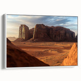 Framed canvas artwork showcasing a serene desert landscape with warm hues of orange and gold, displayed from a side view against a white background, perfect for modern home decor.