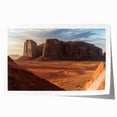 Desert landscape art print showcasing warm hues of orange, red, and yellow, rolled and ready for display, capturing the serene beauty of arid environments.
