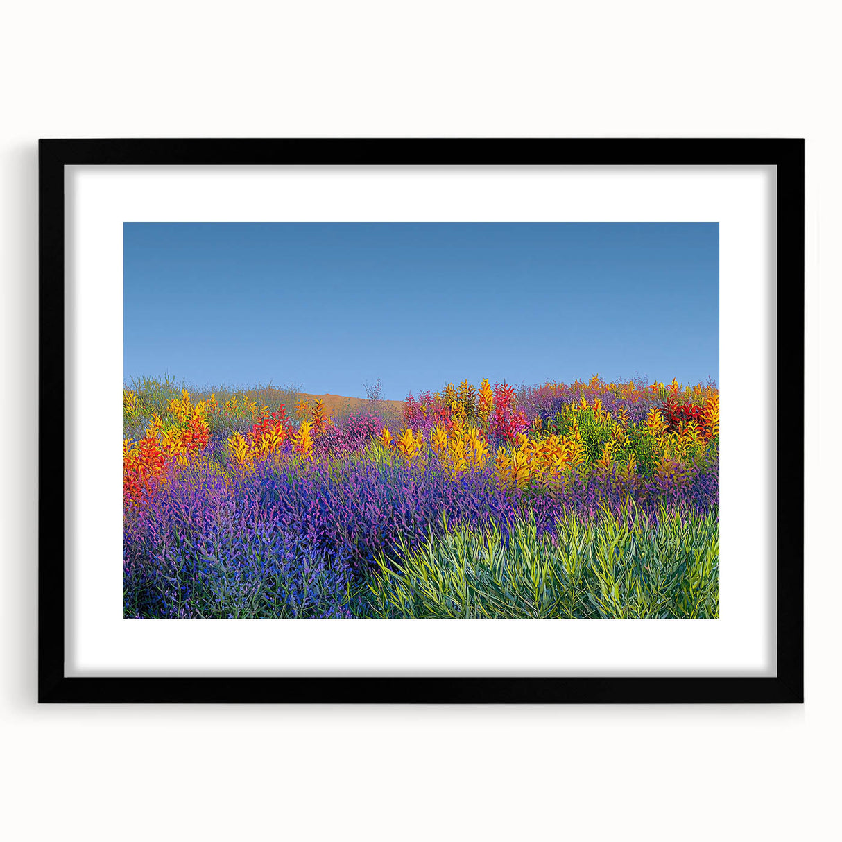 Framed landscape artwork showcasing vibrant green fields and mountains, presented with a sleek black mat, ideal for home décor and enhancing interior aesthetics.