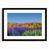 Framed landscape artwork showcasing vibrant green fields and mountains, presented with a sleek black mat, ideal for home décor and enhancing interior aesthetics.