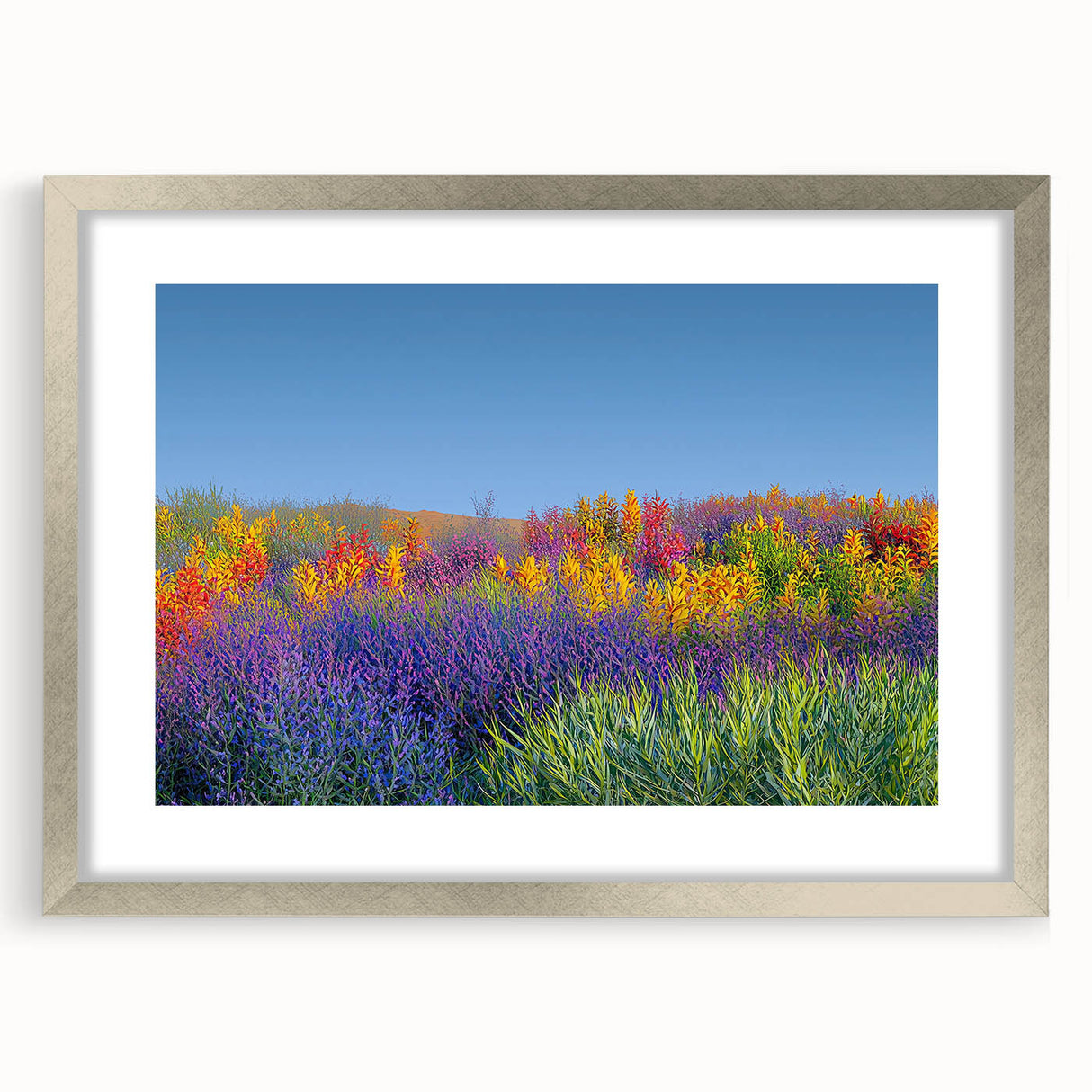 Elegant silver frame showcasing a landscape print of vibrant green fields, accented with a white mat for a refined display, ideal for home decor and interior styling.
