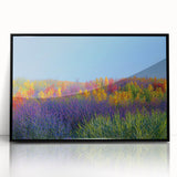 Framed acrylic artwork depicting a vibrant landscape with fields in various shades of green and gold, featuring a sleek black frame, ideal for home decor.