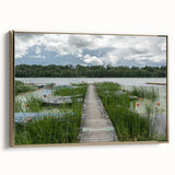 Framed canvas featuring a vintage-style landscape painting of a European scene in muted gold and black tones.