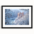 Elegant black-framed landscape artwork depicting a majestic castle surrounded by serene nature, featuring a white mat for a refined presentation, ideal for home decor.