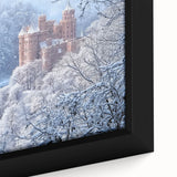 Close-up view of a framed canvas depicting a vibrant landscape with a majestic castle, showcasing rich colors and intricate details, ideal for home decor.