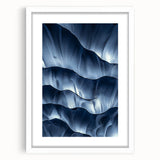 Framed landscape artwork depicting a serene cave scene, featuring earthy tones and a white mat border, displayed in a modern gallery setting.