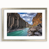 Framed landscape artwork showcasing majestic cliffs in soft hues, accented with a silver mat and frame, ideal for enhancing home decor aesthetics.