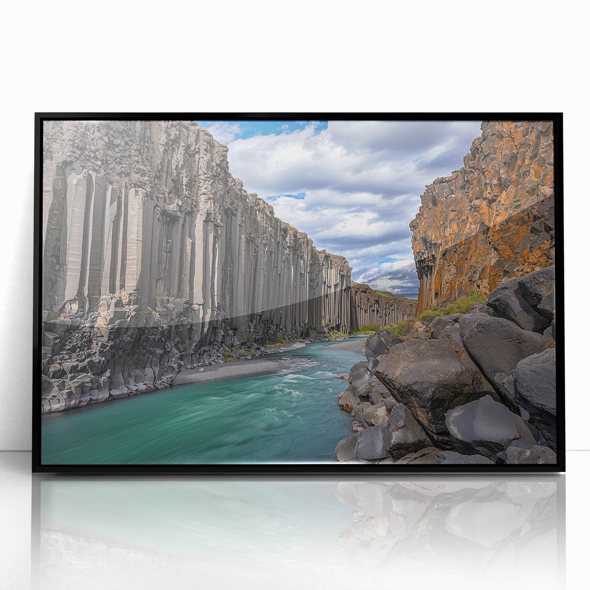 Framed acrylic artwork showcasing a stunning landscape of cliffs, featuring vibrant colors and intricate details, set in a sleek black frame for a modern aesthetic.