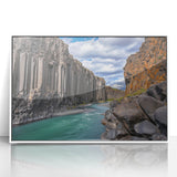 Framed acrylic artwork showcasing a breathtaking landscape with dramatic cliffs and vibrant colors, set against a white frame, perfect for modern decor.