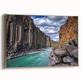 Framed canvas artwork showcasing a vibrant landscape with dramatic cliffs, gold accents, and a side view perspective, perfect for enhancing modern interior decor.