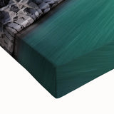 Close-up of a stretched canvas artwork depicting dramatic cliffs and vibrant landscapes, showcasing rich colors and intricate details ideal for home decor or art enthusiasts.