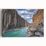 Stretched canvas artwork depicting a dramatic cliffside landscape at sunset, featuring vibrant colors and intricate details, perfect for home decor or art enthusiasts.