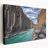 Stretched canvas artwork depicting a stunning landscape of towering cliffs under a vibrant blue sky, showcasing rich colors and intricate details ideal for home decor.