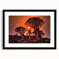 Extra large abstract art print of a colorful, textured African landscape on a framed black mat, ideal for living room decor.