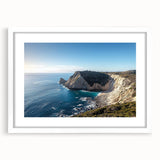 Framed landscape art showcasing dramatic cliffs in vibrant colors, set against a white mat, perfect for enhancing home decor. Ideal for nature lovers.