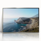 Framed acrylic artwork showcasing a serene landscape of dramatic cliffs and lush greenery, elegantly presented with a silver frame, perfect for modern decor.