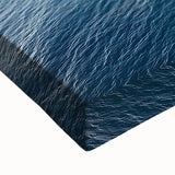 Close-up of a stretched canvas showcasing a vibrant landscape of rugged cliffs and serene skies, ideal for home decor and art enthusiasts.