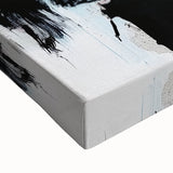 Close-up of a stretched canvas showcasing vibrant abstract splatter artwork, featuring a dynamic blend of colors including blue, yellow, and red, ideal for modern home decor.