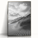 Framed acrylic artwork showcasing a serene dune landscape with soft beige and gold tones, elegantly displayed with a sleek silver frame, ideal for modern decor.