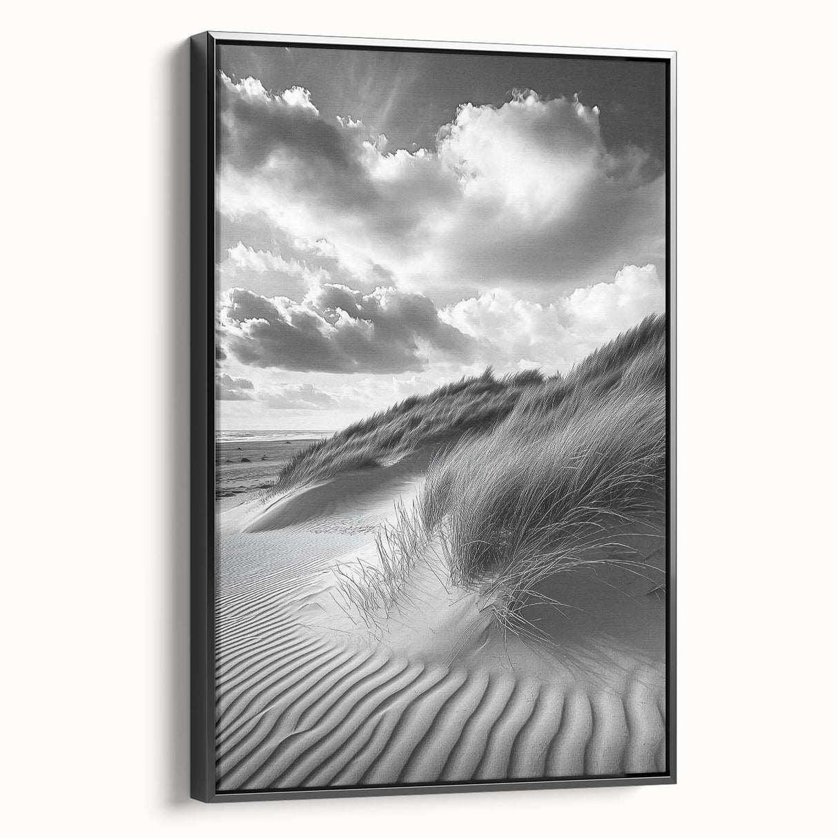 Framed canvas artwork showcasing a serene desert landscape with golden sand dunes, presented in a sleek black frame, perfect for modern decor.