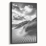 Framed canvas artwork showcasing a serene desert landscape with golden sand dunes, presented in a sleek black frame, perfect for modern decor.