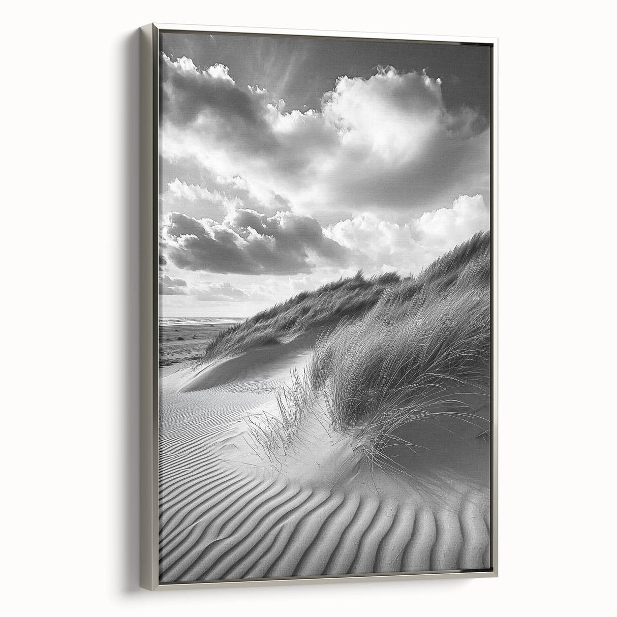 Framed canvas artwork depicting serene sand dunes under a blue sky, showcasing a silver frame that enhances the landscape's tranquil beauty. Perfect for modern home decor.