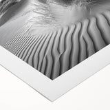 Stunning rolled canvas artwork depicting vibrant desert dunes at sunset, showcasing warm orange and golden hues, elegantly packaged in a protective cardboard tube.