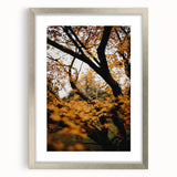 Textured abstract art print in warm autumn hues on a silver-framed canvas, ideal for bedroom wall decor.