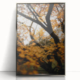 Mid-century modernist art depicting autumn trees in muted orange and brown tones, framed in silver acrylic.