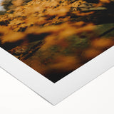 Art deco poster of a stylized fall landscape on rolled canvas, featuring warm orange and brown tones.