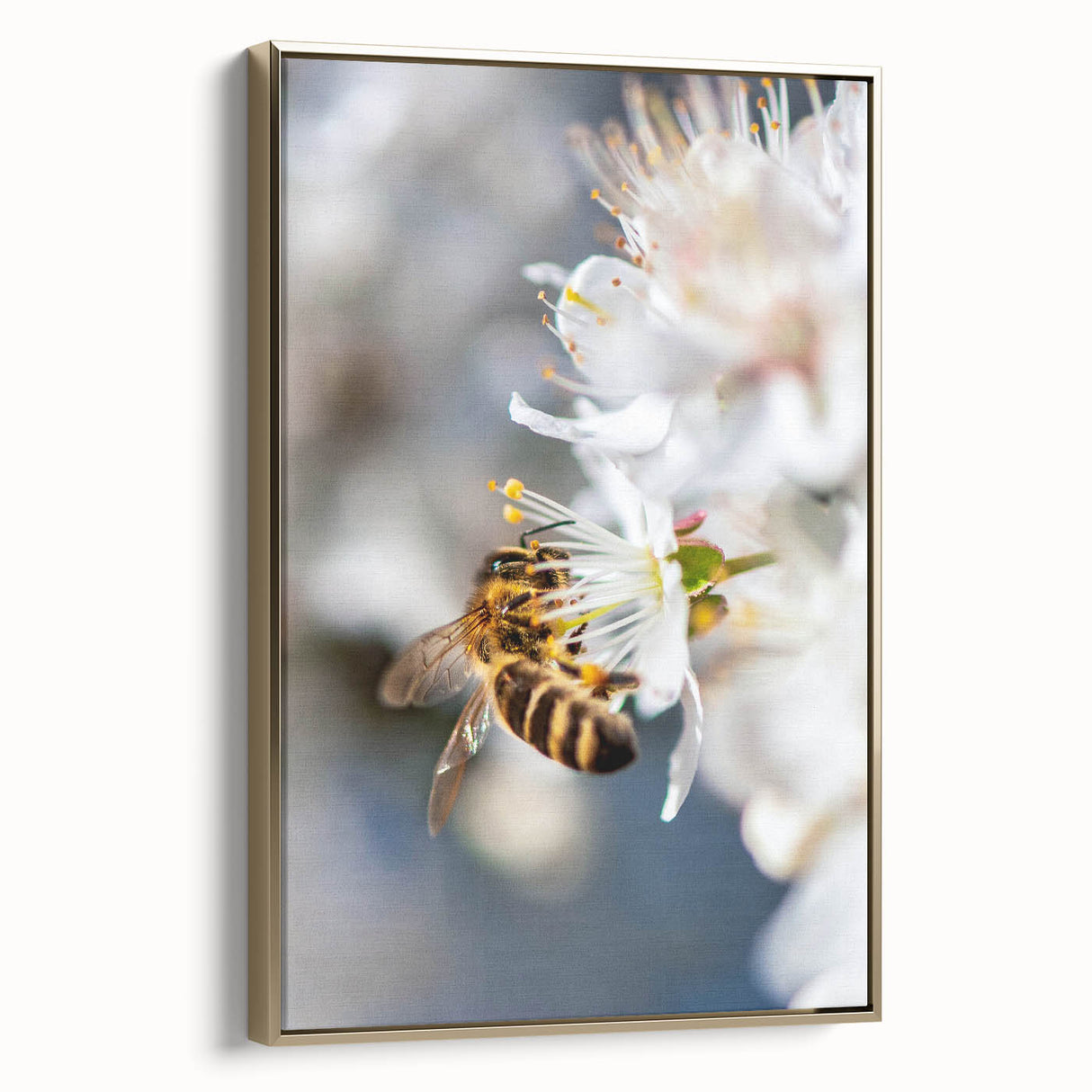 Framed canvas depicting a vintage-style landscape with spring motifs in muted green and gold tones.
