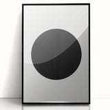 Framed abstract minimalist wall art featuring a sleek black acrylic front, perfect for modern decor, displayed against a neutral backdrop for elegant styling.