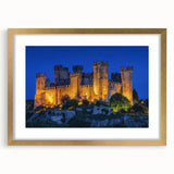 Elegant gold-framed landscape artwork showcasing a majestic castle surrounded by lush greenery, complete with a white mat for added sophistication. Ideal for enhancing home decor with a touch of classic charm.
