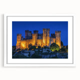 Elegant landscape artwork depicting a majestic castle surrounded by lush greenery, framed in a white mat. Perfect for enhancing home decor with a touch of sophistication.