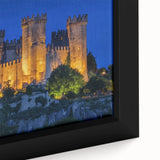 Close-up of a framed canvas showcasing a stunning landscape featuring a majestic castle surrounded by lush greenery, ideal for home decor enthusiasts.