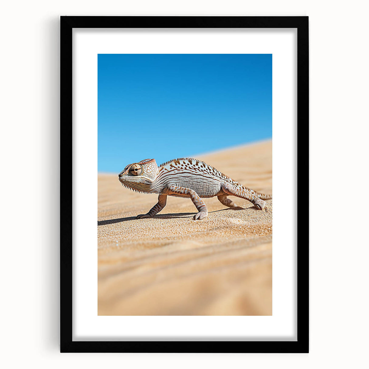 Desert landscape art framed in sleek black with a white mat, showcasing vibrant sandy tones and dramatic skies, perfect for modern home decor.