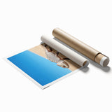 Desert landscape rolled print showcasing vibrant orange and yellow hues, depicting a serene sunset over dunes, packaged in a protective cardboard tube for easy transport.