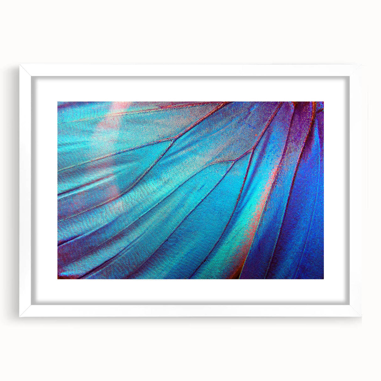 Abstract art print of close-up leaves in muted green tones, framed with a white mat.