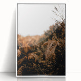 Art deco poster of fall trees in muted orange and brown, acrylic print in white frame, suitable for nursery wall art.