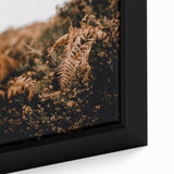 Close-up of a large framed canvas featuring textured black wall art with colorful abstract designs.