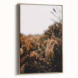 Framed canvas depicting a vintage landscape painting with autumnal trees and a golden color palette.