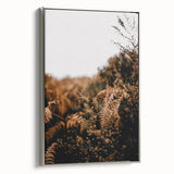 Framed canvas featuring a vintage landscape painting of autumn trees with vivid orange and red leaves.