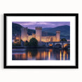 Elegant black-framed landscape artwork featuring a majestic castle surrounded by lush greenery, displayed with a white mat for a refined presentation. Perfect for home decor enthusiasts seeking a touch of sophistication.