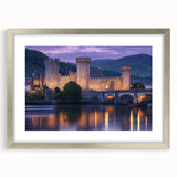 Elegant silver-framed landscape artwork featuring a majestic castle surrounded by lush greenery, with a white mat enhancing its sophisticated look, perfect for home decor.