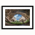 Black-framed landscape artwork displaying intricate cave formations, elegantly matted for a polished look, perfect for enhancing home decor with natural beauty.